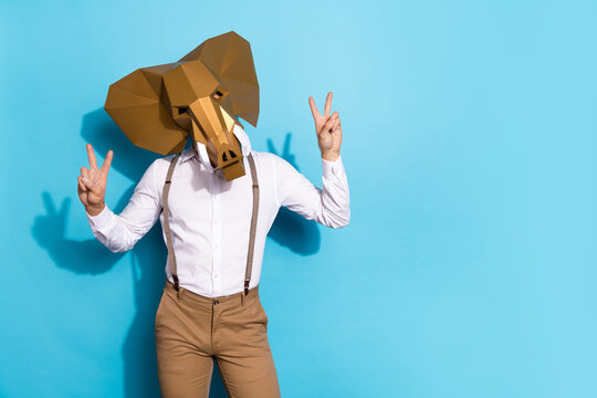 Photo of wacky eccentric man wear elephant mask showing two v-signs empty space isolated blue color background