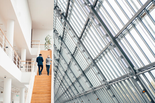 Business partners walking on staircase in office