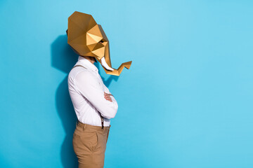 Photo of extravagant confident guy dressed wild animal mask empty space arms folded isolated blue...