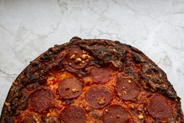 pepperoni pizza on marble counter