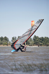 Windsurfer surfing on a windy summertime day at the river.