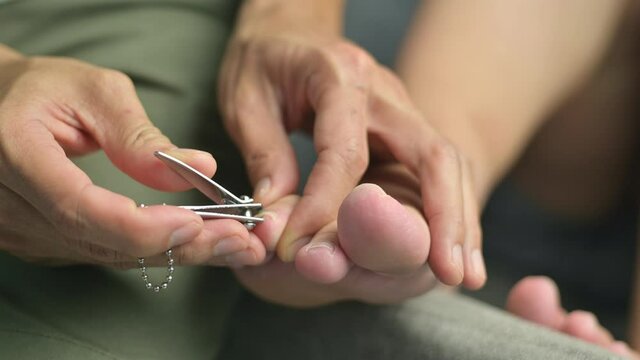 Husband cuts his wife's toenails