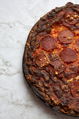pepperoni pizza on marble counter