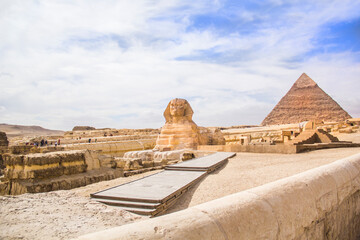 Great Sphinx against the background of the pyramids of the pharaohs Cheops, Khafren, and Mikerin in...