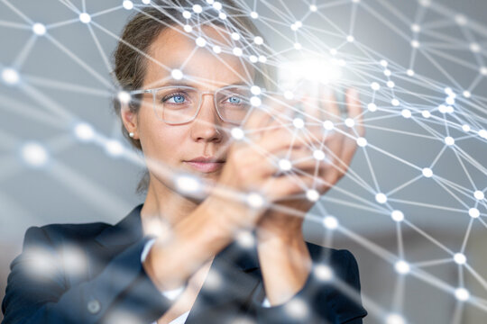 Businesswoman holding object connected with networking symbol