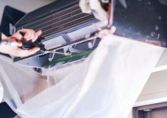 Fototapeta premium Cleaning Air conditioner in living room