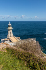 lighthouse on the coast of the Cantabrian Sea in the Basque country with a blue sea and sky