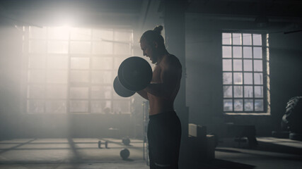 Sportsman breathing heavy before strength exercise. Man lifting weights in gym