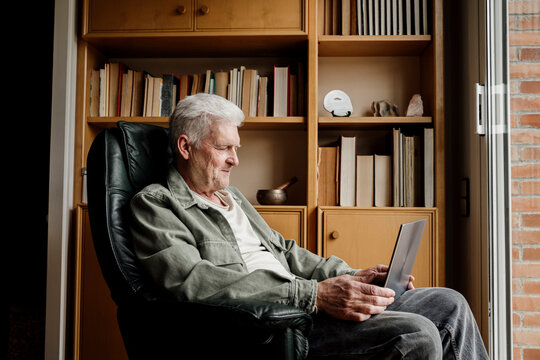 Senior man using laptop at home