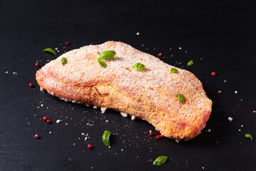 Food concept uncooked Veal cordon bleu on black slate stone board with copy space - obrazy, fototapety, plakaty