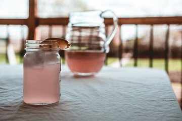 Close up of Pink lemonade with lemon wedge on table