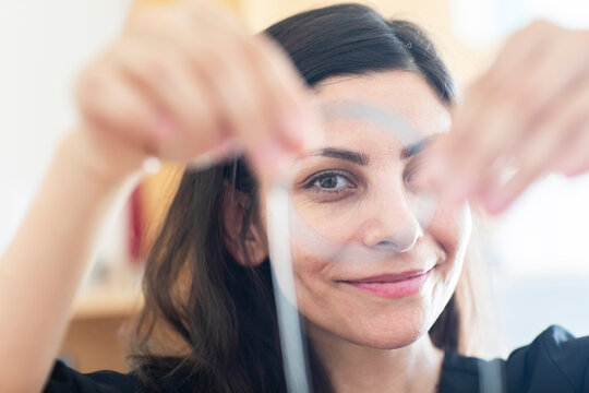 Smiling Businesswoman Looking Through An Object