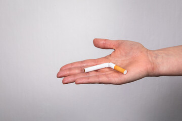 Quit smoking concept. Close up woman's hand holding a cigarette