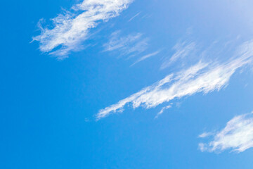 Blue sky with chemical clouds chemical sky chemtrails sunny day.