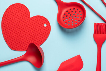 Red silicone heart and kitchen utensils. Kitchen banner for Valentine's Day. I cook with love.