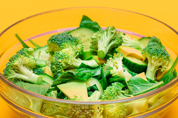 Fresh Green Salad of Avocado, Broccoli, Spinach and Cucumber for Body Detoxification. Vegan Salad. Vegetarian Culture. Raw Food. Healthy Eating and Vegetable Diet