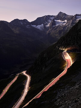 High angle view of light trails on mountain pass against sky at dusk, South Tyrol, Italy