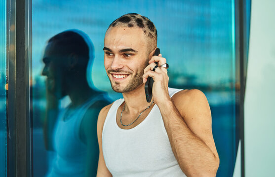 Smiling eccentric man talking on smartphone