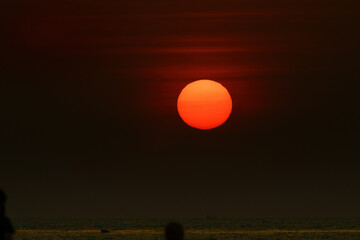 PATTAYA, THAILAND The sun is red and round, beautiful. Beach in Pattaya Bay