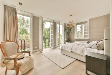 Interior of cozy bedroom with bedroom and armchair and carpet