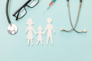 Family health care therapy medical concept. Family cutout symbol model stethoscope glasses syringe on blue background. Health check up life insurance concept. Clinic hospital for parents child banner
