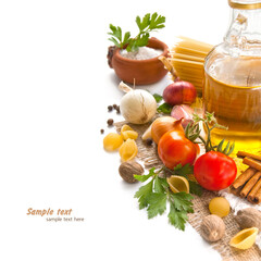 Pasta, vegetables, spices and oil on the table for Italian food