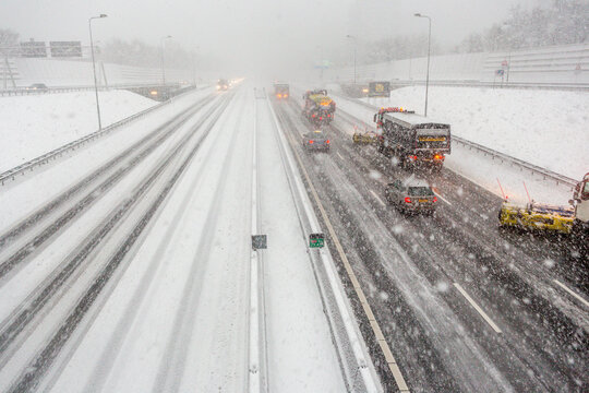 Snow shovels clean the A10 highway ring in Amsterdam during a heavy snow storm in the Netherlands.