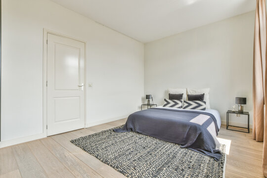 Interior of bedroom with bed near windows