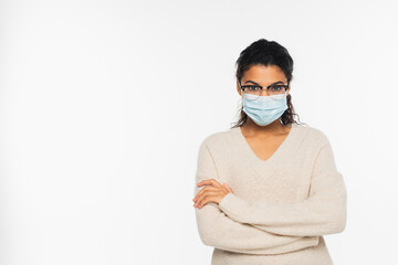 African american woman in eyeglasses and medical mask standing with crossed arms isolated on white.