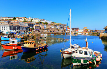 Mevagissey Cornwall fishing boats in harbour colourful English coast scene