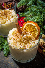 Risgrynsgrot, scandinavian-style Christmas rice porridge with cinnamon and spices, with Christmas tree branches decor 