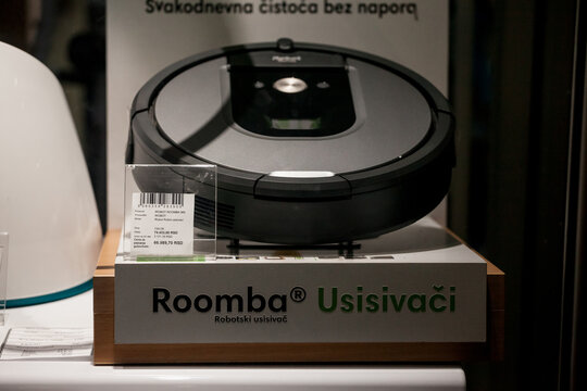 BELGRADE, SERBIA - OCTOBER 31, 2021: Selective blur on iRobot logo in front of a roomba vacuum cleaer for sale in Belgrade, Roomba is a robot vacuum cleaner developed by a technology company, iRobot
