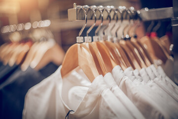 Shirts on hangers. Shopping in store. Clothes on hangers in shop for sale
