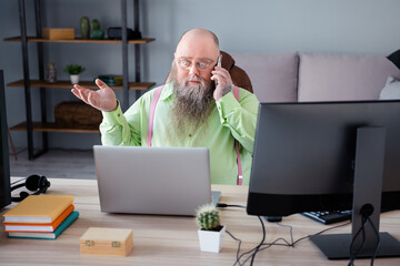 Portrait of attractive focused skilled shocked guy calling client discussing order web design at...