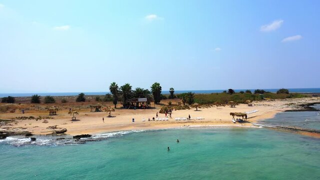 Aerial Panning Beautiful Shot Of Palm Islands Against Sky, Drone Flying Over Sea During Sunny Day - Tripoli, Lebanon