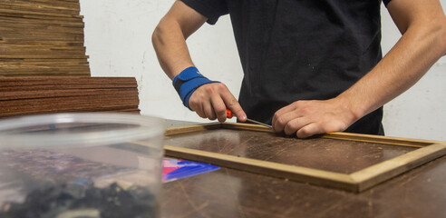 framemaker using his hands to finish his job