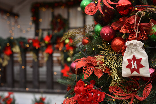 Christmas background. Advent calendar in the form of an eco bags hangs on the background of a Christmas porch.Christmas gifts and tasks - Powered by Adobe