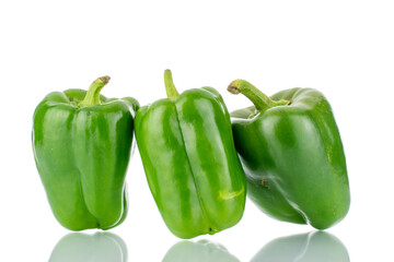 Three sweet green peppers, close-up, isolated on white.