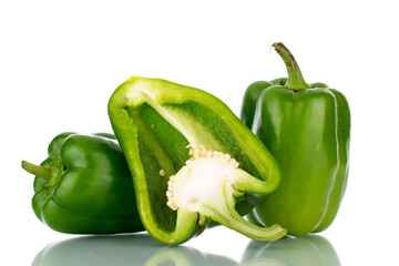 Two whole and one half of sweet green peppers, close-up, isolated on white.
