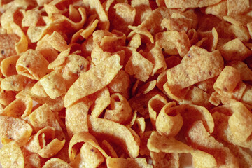 overhead view tasty snack corn chips pile on kitchen counter as junk food background