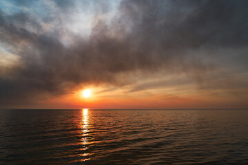 Sea sunset. Smoke wildfires sweeping across the sky.