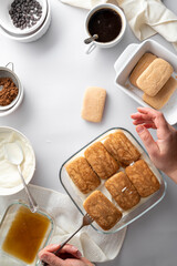 Tiramisu cake step by step recipe. Ingredients for cooking tiramisu dessert, grey background, vertical image.