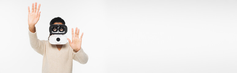 African american woman in sweater and vr headset gesturing isolated on white, banner.