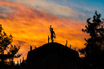 silhouette of a statue at sunset