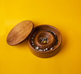wooden jewelry box with yellow background