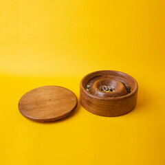 wooden jewelry box with yellow background