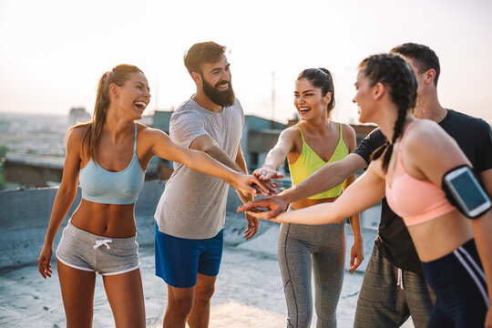 Fitness, sport, friendship and healthy lifestyle concept. Group of happy people exercising outdoor.
