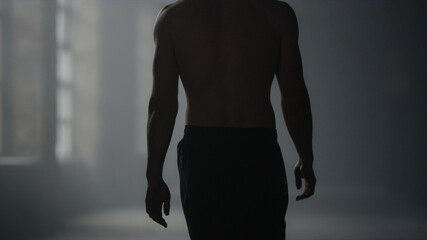 Fototapeta premium Guy walking in loft building. Male athlete finishing workout
