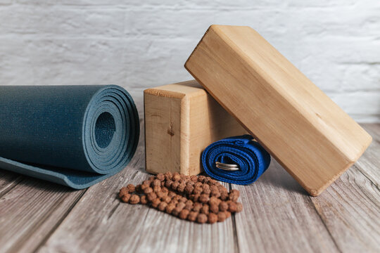 Various yoga props on studio wood floor. Set of blocks in wicker