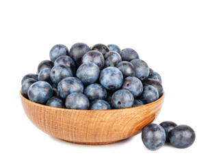 Blackthorn fruits in a cup isolated on a white background